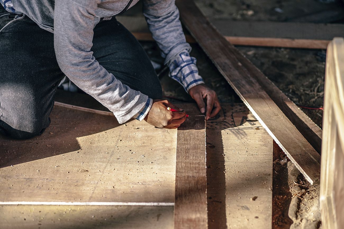 A contractor working on a wooden
